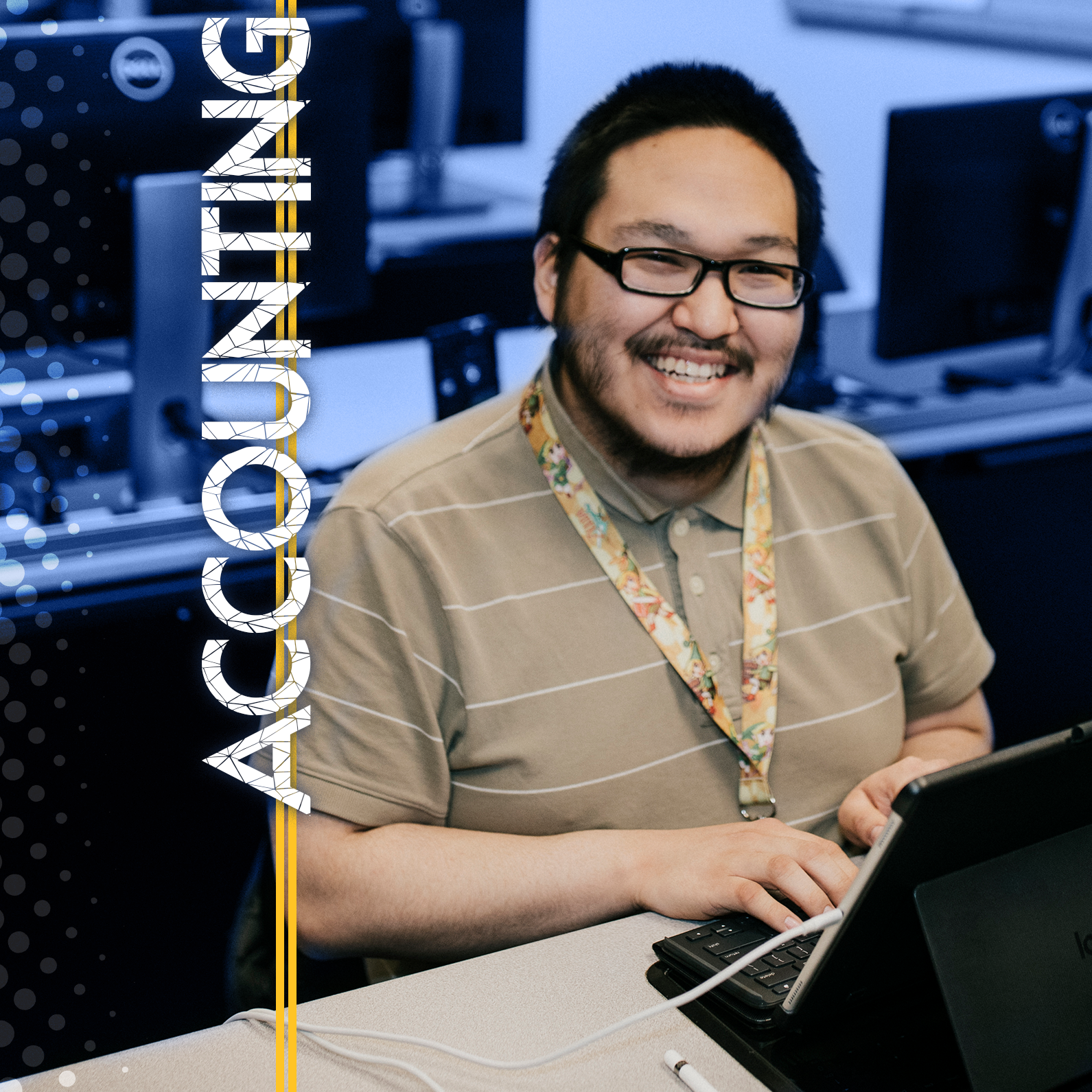 Male students smiles from behind a computer with the word "Accounting" in the foreground.