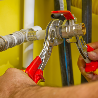 Plumber working on pipes.